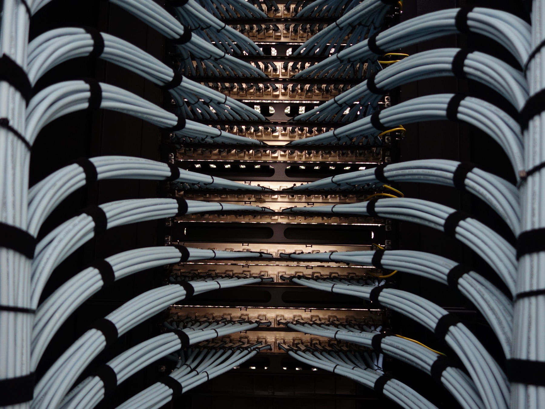 Structured cabling dressed into patch panels — symmetrical and labelled.