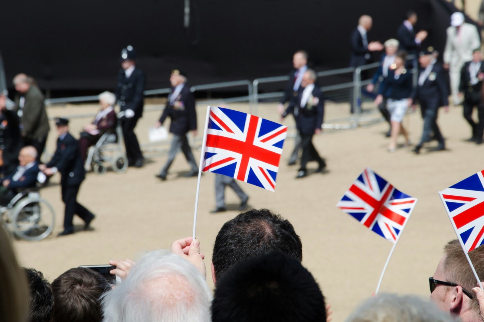 Union Jack flags held up by a crowd at a UK community event — the kind of organisation UKNode sponsors with free charity hosting.